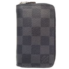 Introducing the Louis Vuitton Zippy Coin in Damier Graphite - a sleek and practical accessory for the modern individual. Crafted from the iconic Damier Graphite canvas, this compact wallet exudes sophistication and style. The secure zip-around closure ensures your coins and cards are kept safe and organized.Featuring a well-organized interior with multiple card slots and a central zipped pocket, the Zippy Coin offers convenience without compromising on elegance. The subtle Louis Vuitton signature adds a touch of luxury to this versatile piece. Perfect for everyday use or as a chic addition to your designer collection.Make a statement with the Louis Vuitton Zippy Coin in Damier Graphite - a timeless accessory that combines functionality with impeccable design. Elevate your everyday style wi Louis Vuitton Design, Compact Wallet, Grey Coat, Timeless Accessories, Fendi Bags, Prada Bag, Dior Bag, Louis Vuitton Damier, Chanel Bag