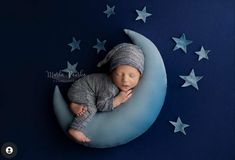 a newborn baby sleeping on the moon with stars around it's head, taken from above