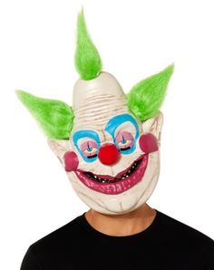 a man wearing a clown mask with green hair