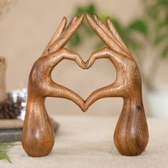 two wooden hands making a heart shape