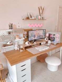 a desk with two computer monitors on top of it next to a teddy bear and other items