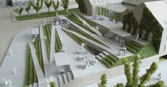 a model of a building surrounded by trees and people