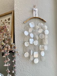 a wall hanging made out of plastic cups