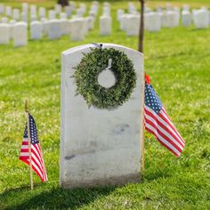 wreaths and american flags are placed in front of the headstones of those fallen soldiers