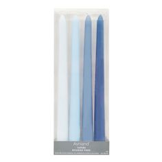 three blue and white candles sitting in a package