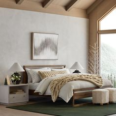 a bedroom with white walls and wooden furniture