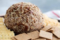 a ball of food sitting on top of crackers next to crackers and cheese