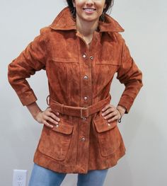 "This is an awesome vintage 70s jacket.  Features an attached belt and buttons, two front pockets. It is a heavy-duty coat.   This jacket will be sure to keep you warm on those chilly evenings.   In good condition with slight wear as you can see in the pics.   Order this item today! Size: Fits like a medium/Large 17\" shoulders 23\" arms 18\" waist (where the belt is) 24\" across at the bottom 27\" top to bottom length" Leather Outerwear With Snap Closure For Fall, Vintage Leather Outerwear For Fall, Vintage Long Leather Jacket For Fall, Retro Belted Fall Outerwear, Retro Belted Outerwear For Fall, Brown Outerwear With Button Closure For Fall, Fall Outerwear With Belt Loops, Vintage Outerwear With Snap Buttons For Fall, Vintage Brown Buttoned Outerwear For Fall