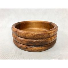 three wooden bowls stacked on top of each other