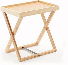 a small wooden table with two legs and a tray on the top that holds a knife