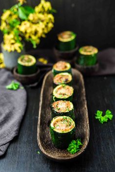 cucumbers are arranged on a wooden platter and garnished with parsley