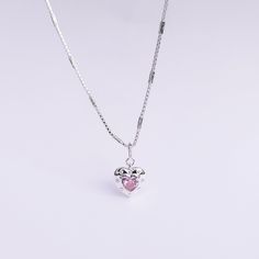 Introducing our Pink Glam Heart Necklace - crafted in Sterling Silver with a heart-shaped pink crystal at its core. This unique chain necklace features a sparkling pink crystal heart pendant, on a Sterling Silver heart shape base adding sophistication to any look. Wear it long or short with the adjustable clasp. Elevate your style with this enchanting piece that radiates love and glamour. Main Stone: heart shaped lab diamond Stone Color: pink Metal Material: 925 Sterling Silver Chain Lenght: 16 Pink Heart Pendant Clavicle Necklace, Rose Gold Heart Pendant Crystal Necklace, Pink Heart Cut Birthstone Necklace, Crystal Heart Jewelry With Heart Charm, Heart Charm Crystal Jewelry, Pink Heart-shaped Jewelry With Clavicle Chain, Pink Heart-shaped Clavicle Chain Jewelry, Pink Heart Necklace With Adjustable Chain, Pink Heart Charm Round Pendant Jewelry