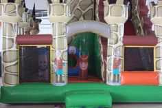 an inflatable bounce house with giraffes and other decorations on display