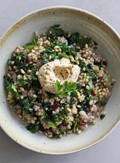 a white bowl filled with food on top of a table