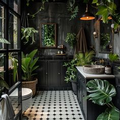 a black and white tiled bathroom with potted plants