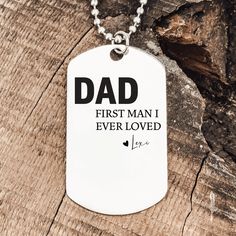 a dog tag that says, dad first man i ever loved is on a chain