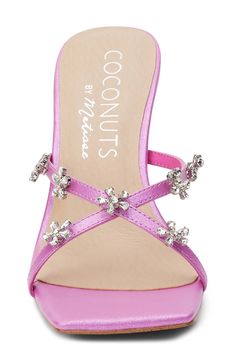 Sparkling crystal flowers dot the slim crisscross straps of a slide sandal balanced by a squared-off toe and an angled block heel. 3 3/4" heel Synthetic upper, lining and sole Imported