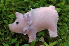 a pink stuffed animal laying in the grass