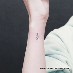 a woman's arm with a small wrist tattoo on her left hand and the word sw in black ink