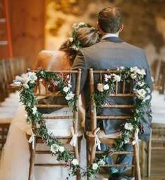 the bride and groom are sitting on their chairs