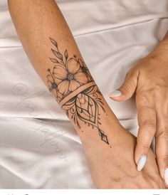 a woman's arm with a flower tattoo on it