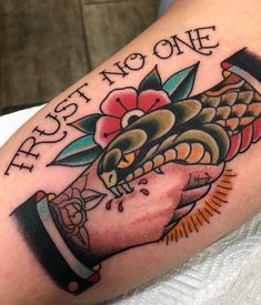 a close up of a person's arm with a tattoo on it that says first no one