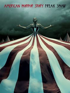 a woman standing on top of a giant red and white striped tent under a cloudy sky