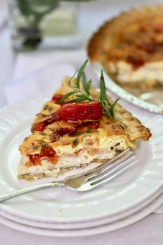 a slice of quiche on a plate with a fork next to the rest of the pie