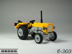 a lego model of a yellow tractor