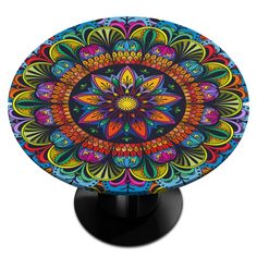 a colorful circular object on a black stand with an intricate design in the middle and bottom