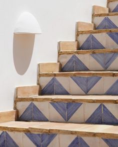 blue and white tiled steps leading up to a light