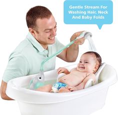 a man is washing a baby in a bathtub