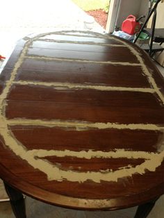 a wooden table with white paint on it