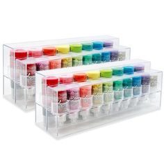 two clear acrylic storage containers filled with different colors of nail polish