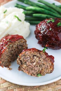 meatloaf on a plate with mashed potatoes and green beans