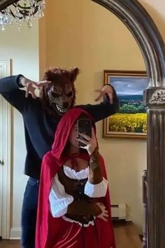 a man and woman dressed up in costumes taking a selfie