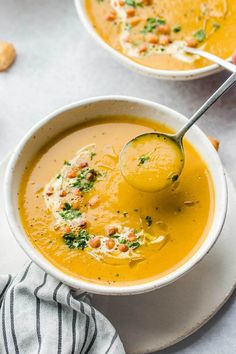 two bowls filled with soup on top of a table