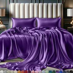 an image of a bed with purple sheets and pillows in the room that is decorated