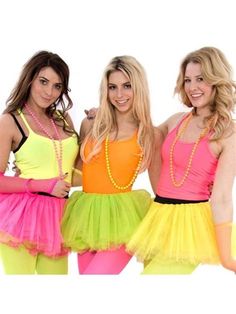 three beautiful young women standing next to each other wearing neon colored dresses and necklaces