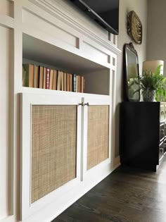 an entertainment center with bookshelves and plants