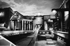 a black and white photo of a building with stairs leading up to the top floor