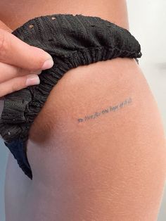 a woman's thigh with the words we are not girls written on it and a black scrunched piece of fabric