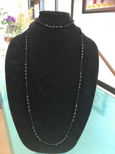 "This stunning necklace modeled after one wore by Lady Mary in the Downton Abbey series manages to be impossibly delicate yet incredibly dramatic at the same time. It is made from 50\" of tiny, 2mm glittering faceted black spinel beads interspersed with sections of smooth 6mm polished black onyx. This is a VERY long necklace in the style of that day. It can be worn as one long necklace (if you're tall or going for the true '20s look) but it's also meant to be looped again over the head, as a cho Elegant Black Spinel Jewelry With Faceted Beads, Formal Long Beaded Chain Necklace, Elegant Single Strand Necklace For Evening, Luxury Evening Jewelry With Round Beads, Elegant Crystal Lariat Necklace With Beaded Chain, Elegant Lariat Crystal Necklace With Beaded Chain, Elegant Beaded Chain Lariat Crystal Necklace, Luxury Jewelry With Round Beads For Evening, Elegant Black Beaded Pearl Necklace