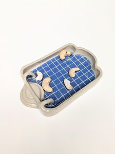 a cookie tray with cookies in it on a blue and white tableclothed surface