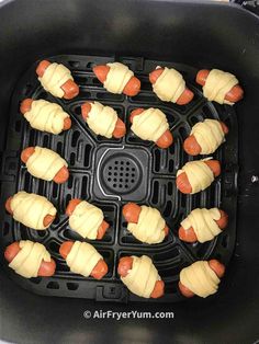 hotdogs wrapped in cheese and ketchup are cooking in an air fryer