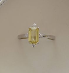 Yellow sapphire engagement ring. Promise ring. Emerald cut engagement ring. 5 stone ring. White gold engagement ring by Eidelprecious by EidelMini on Etsy https://www.etsy.com/listing/596798673/yellow-sapphire-engagement-ring-promise Sapphire Engagement Ring Silver, Yellow Sapphire Engagement Ring, Yellow Sapphire Ring Engagement, Yellow Sapphire Ring, 14k White Gold Diamond Ring, Yellow Sapphire Rings, White Gold Set, Emerald Engagement Ring Cut, Sapphire Engagement Ring Blue