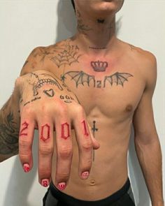 a shirtless man with his hands painted red and holding the number 2011 on his left hand