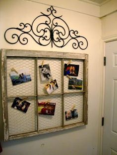 an old window has pictures on it and is hanging on the wall with magnets