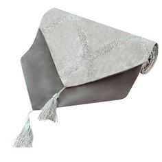 a gray and white blanket with tassels on it's end, laying down