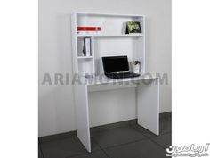 a laptop computer sitting on top of a white desk next to a book shelf with books